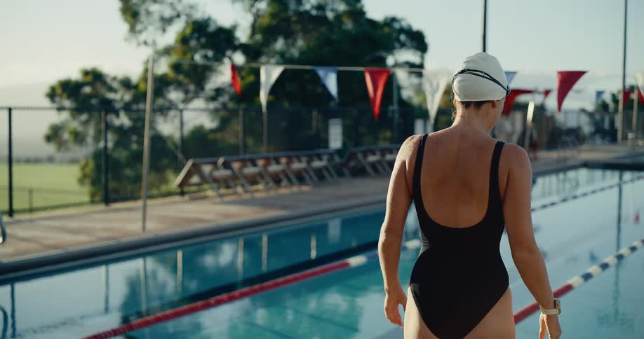 The swimmer walks by the pool