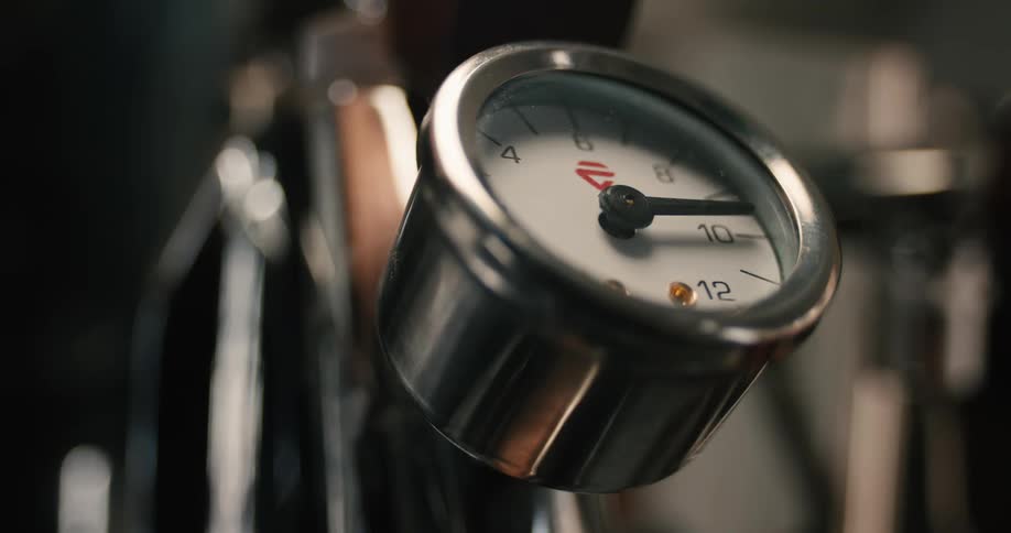 Needle moves on the gauge attached to a metal machine