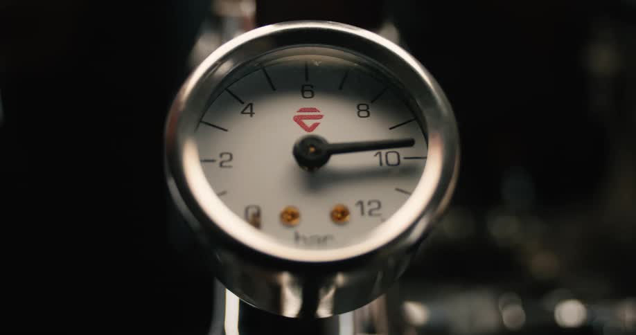 A closeup shot focuses on a chromeringed pressure gauge as its needle rapidly rises from 0 to 10