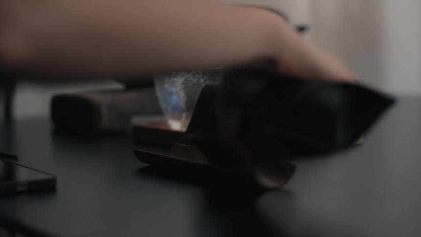 A person pouring tea leaves from a bag