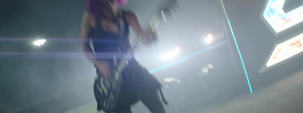 The band are performing in front of flashing lights
