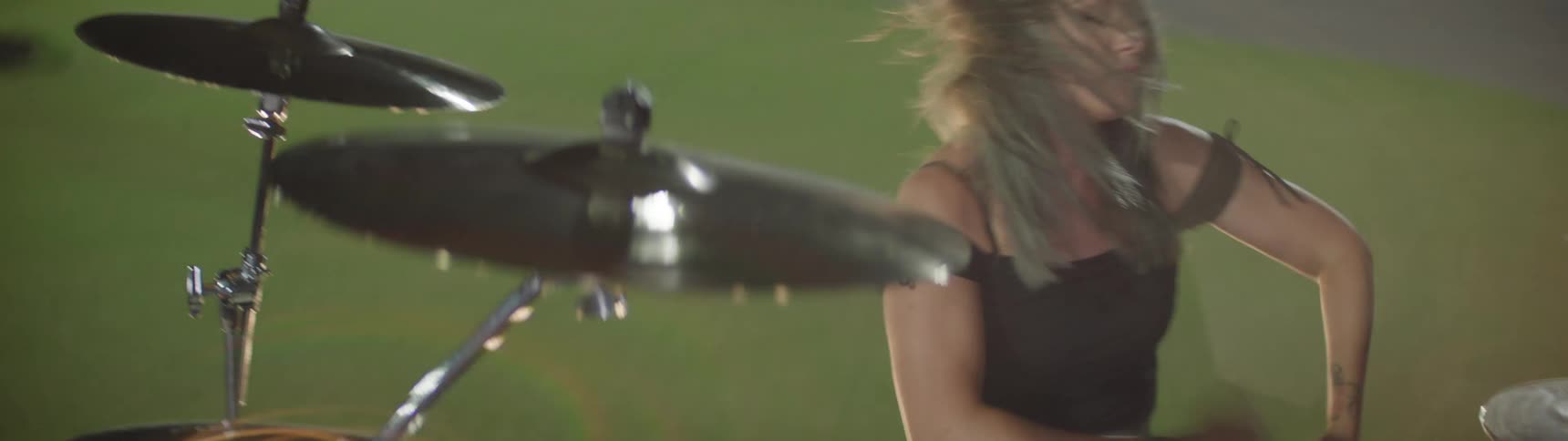 A woman playing drums outdoors