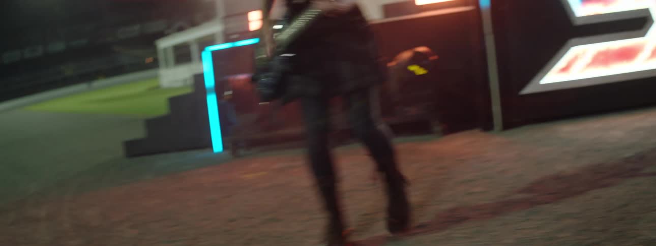 Woman jumps as she plays guitar with her band during a concert