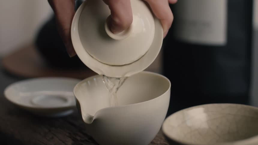 A person pouring a cup of tea