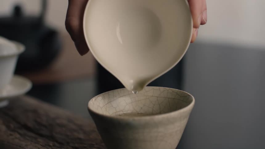 A person pouring water into a cup