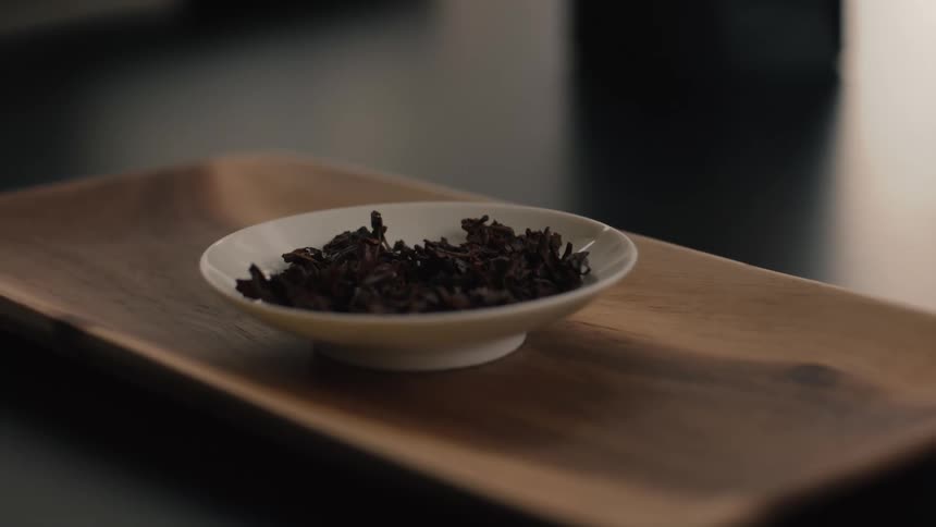 Tea leaves are on the white saucer