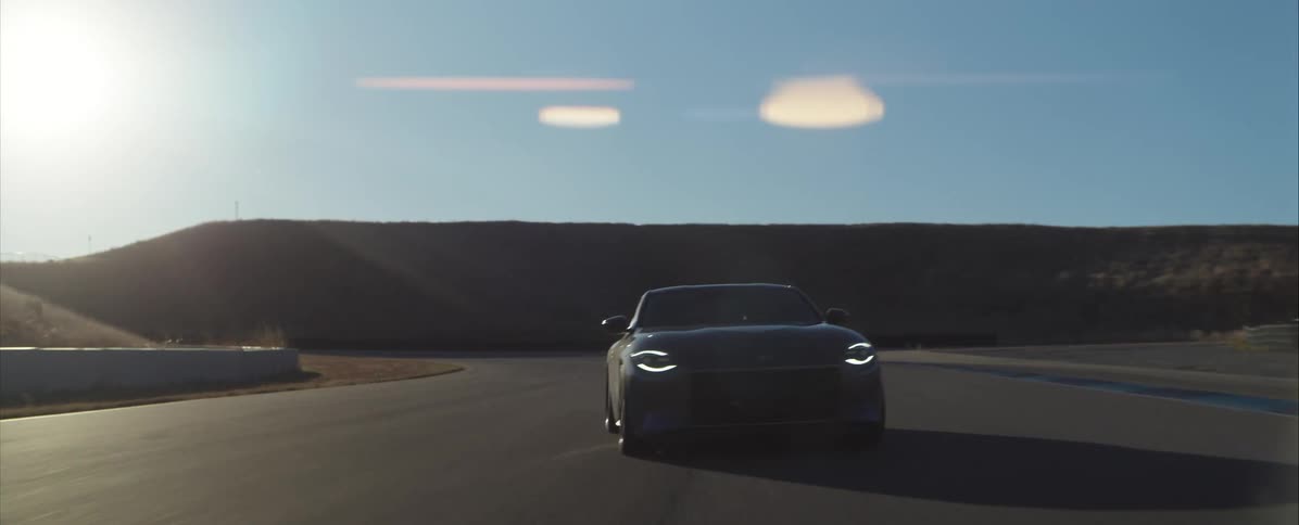 Black sports car travels fast making sharp and wild curves on the highway