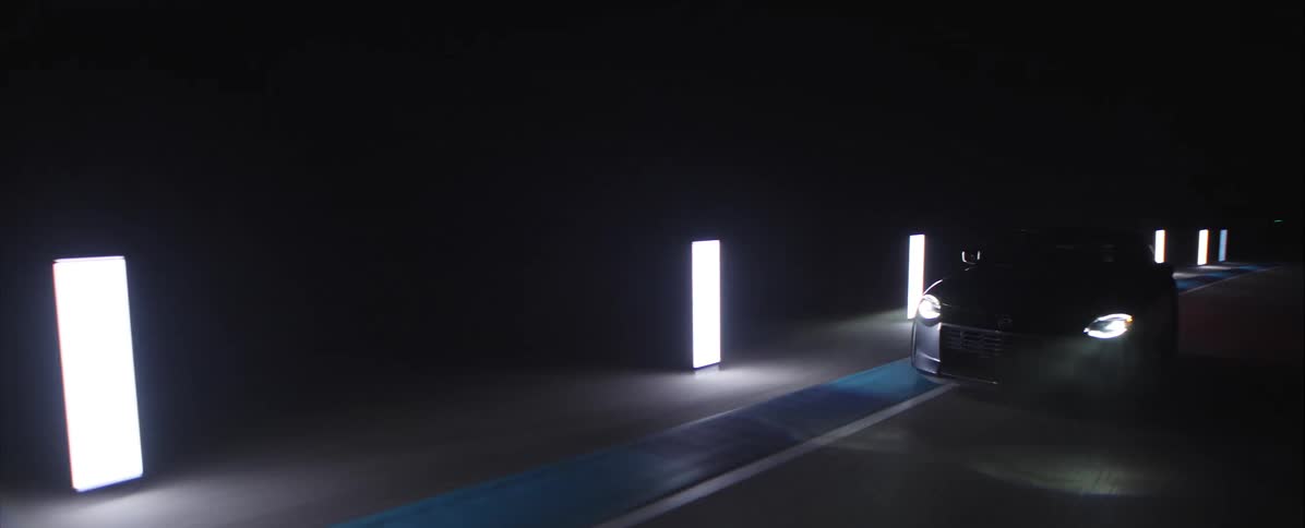 A car driving down a road at night