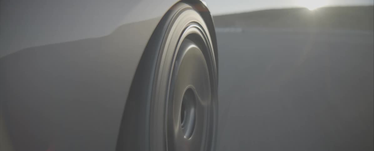 The tire on the car is in view as the car goes around the track