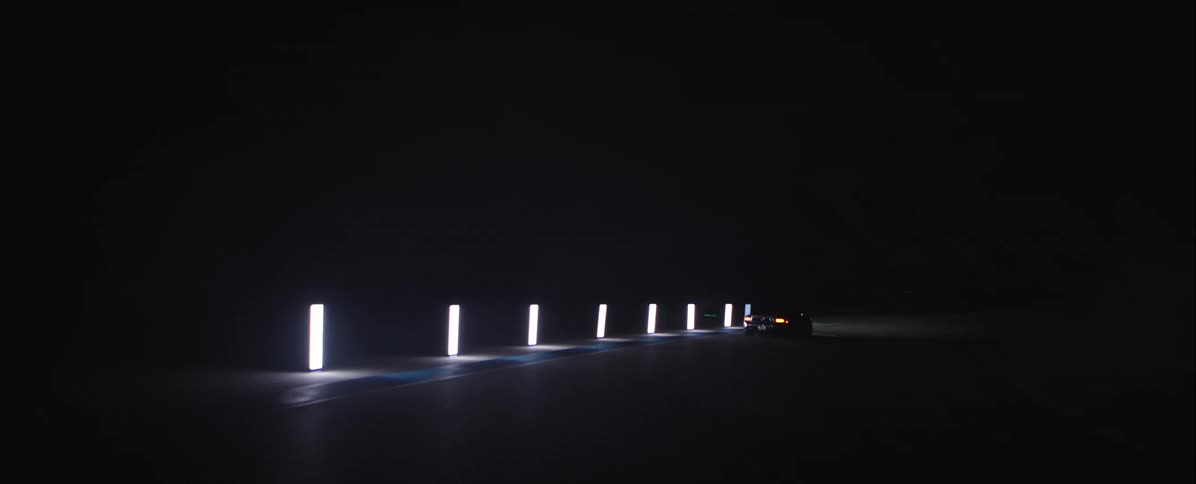 The car speeds on the runway at night