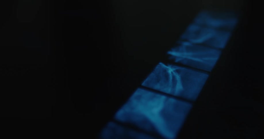 Closeup of abstract blue squares glowing against a dark background