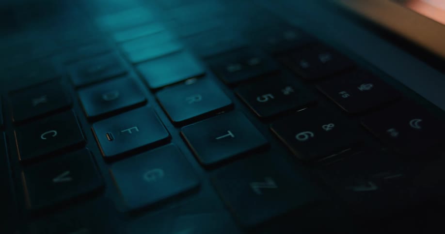 Light reflects on the laptop keyboard