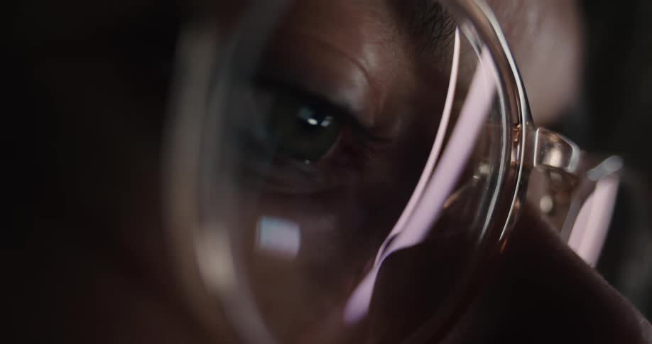 An up close shot of a persons face from the nose up showing eyeglasses