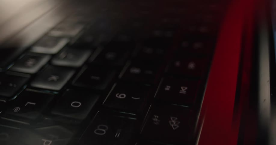 The camera is moving down the length of the black keyboard