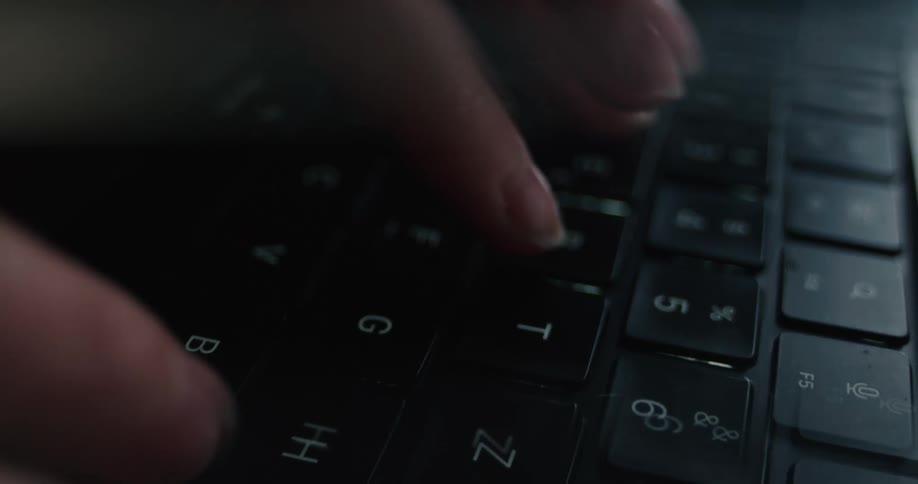 The person is typing on their laptop