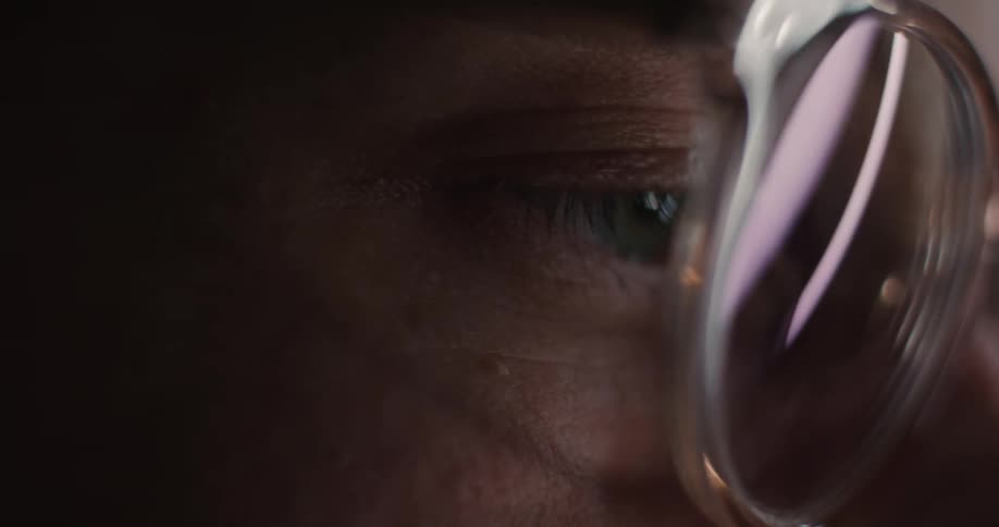 A close up of a persons eye through eyeglasses