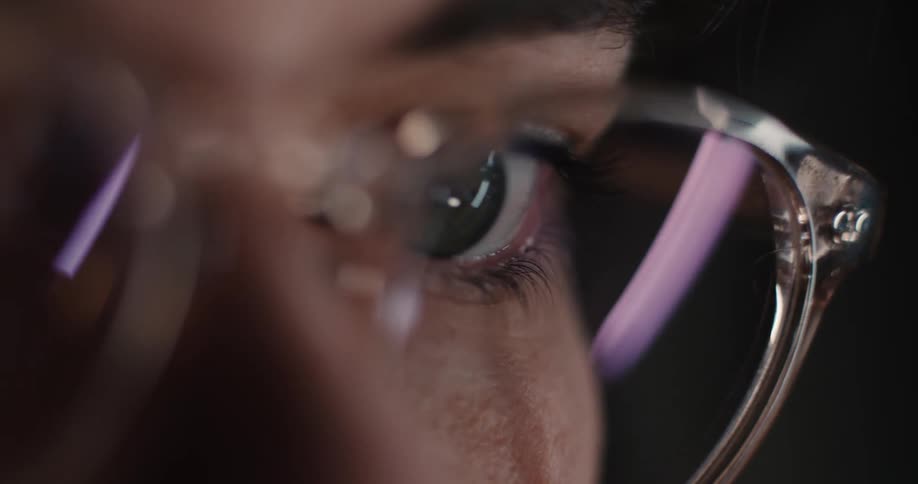 A close up of a persons face wearing glasses