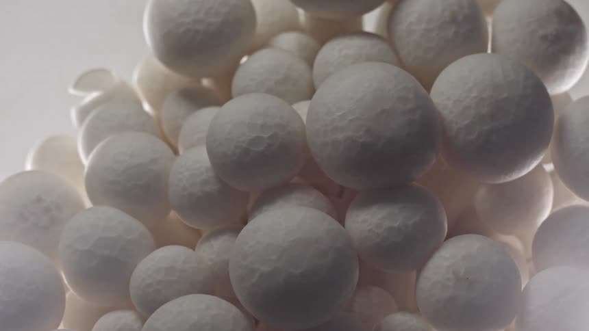A closeup of clustered matte white spheres creating a soft textured pattern