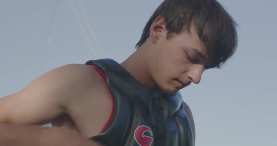 Young man adjusting a sports vest outdoors