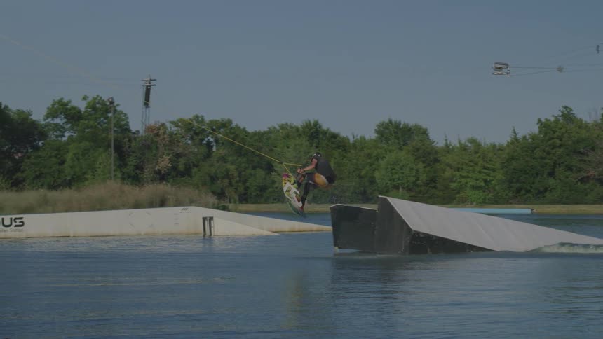 A man wakeboarding off a jump