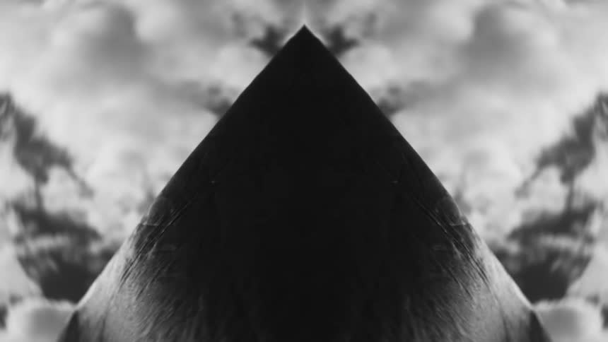 A triangle growing in front of clouds