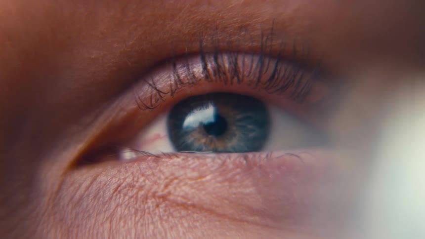 Closeup of a human eye with detailed eyelashes and skin texture
