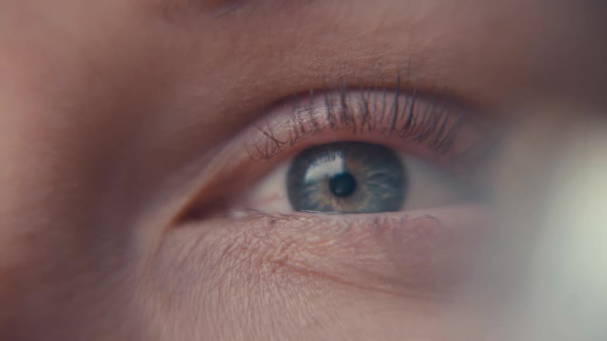 Human eye in closeup with a blue iris in focus