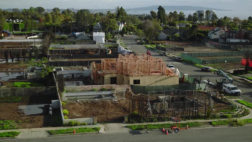 Construction site with a wooden frame structure in a residential neighborhood
