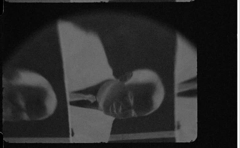 Close up of a black and white camera film containing multiple male portraits