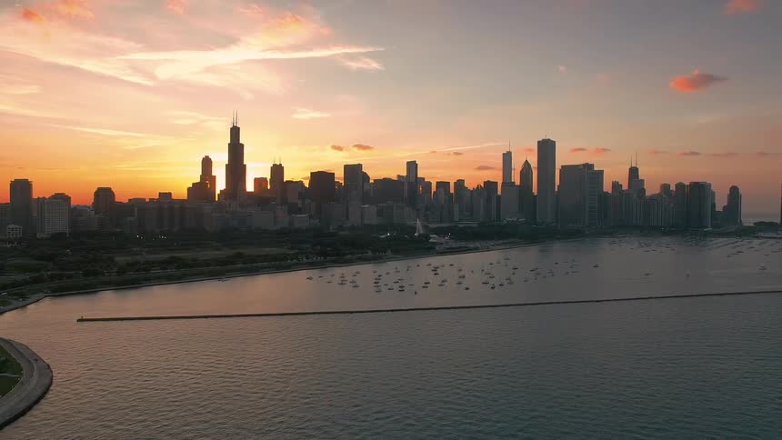 Aerial of a metropolitan city skyline at sunset
