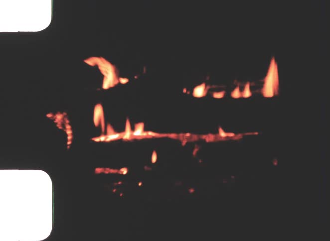 Close up of a burning fireplace indoors at night