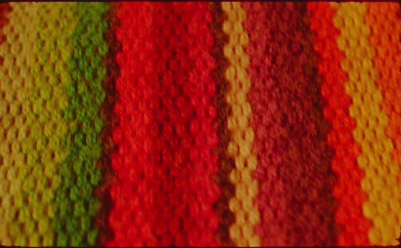 Colorful fabric with vertical stripes in shades of green yellow and red