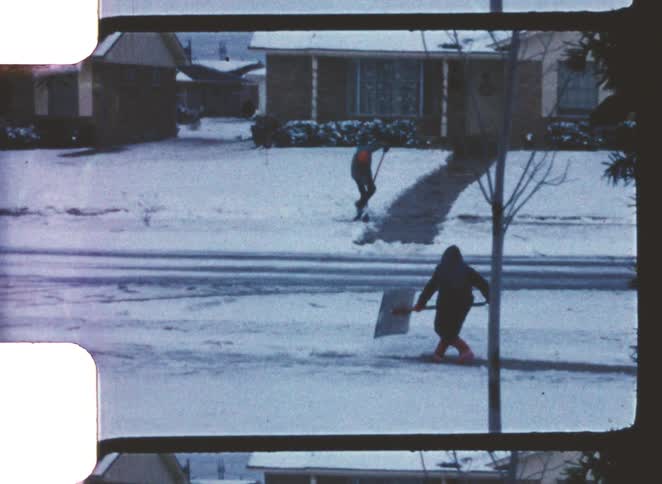 Tow children shoveling snow
