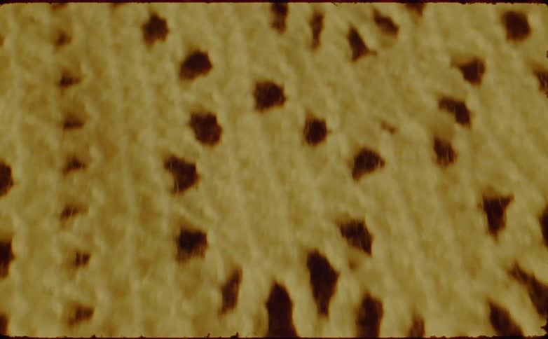 A piece of fabric also has patterns and gaps woven into its surface