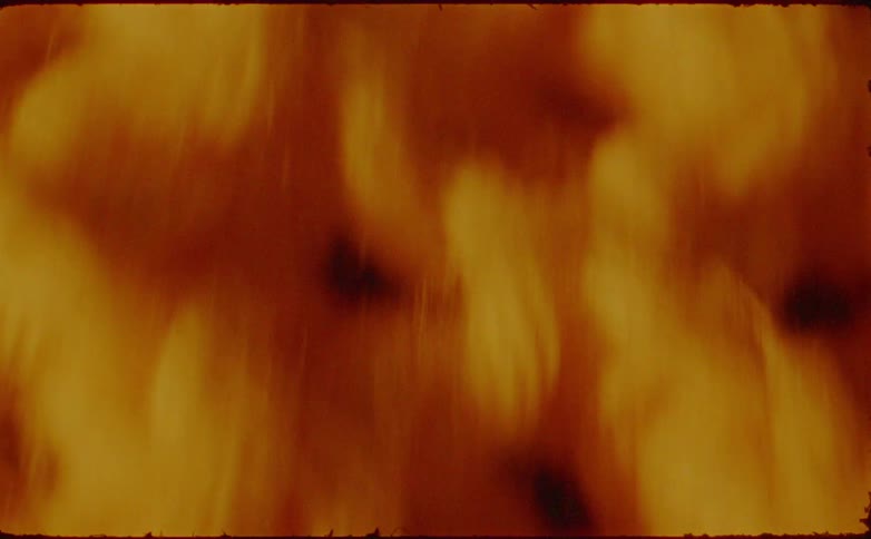 The video shows a closeup highly magnified abstract texture resembling yarn or fibers initially in an orangebrown color with visible strands and threads