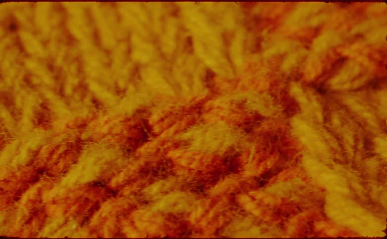 Yellow and orange wool yarn texture in closeup