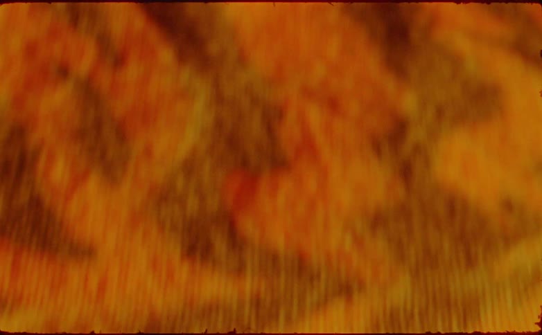 A closeup of the surface of a woven piece of fabric with colorful designs on it