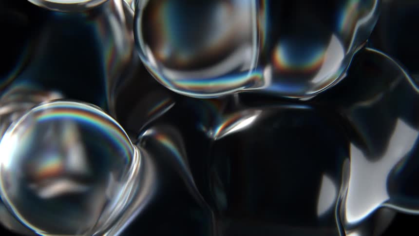 Multiple blobs of liquid slowly touch each other and fuse together
