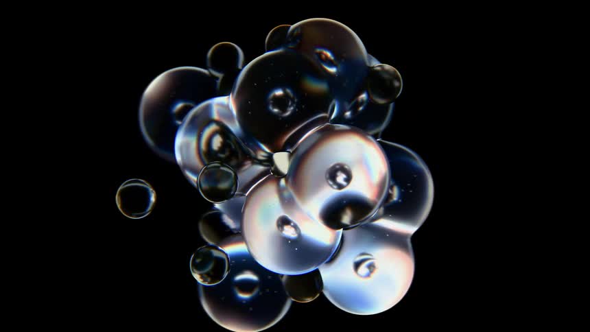 Close up of abstract multicoloured reflective bubbles forming together against a dark background