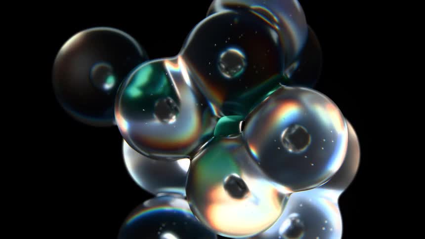 Multiple spheres of liquid slowly float and merge into each other