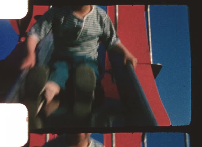 The boy slides down the slide in the playground