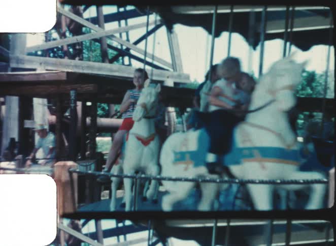 A group of kids riding a merry go round