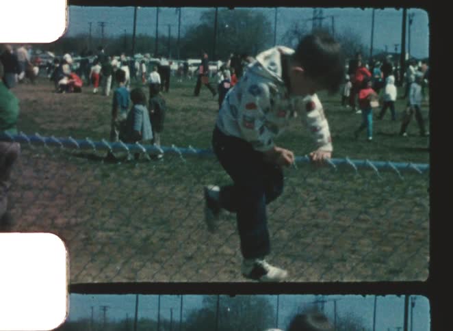 A child climbing over a fence