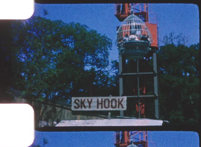 Amusement park structure with an elevated cagelike cabin and a sign reading sky hook