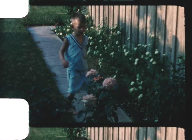 The child walks in his yard