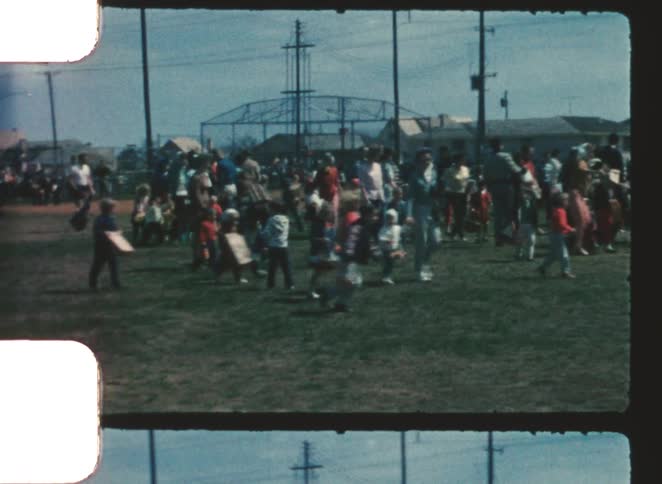 Large crowd of kids in a public park enjoying a nice time