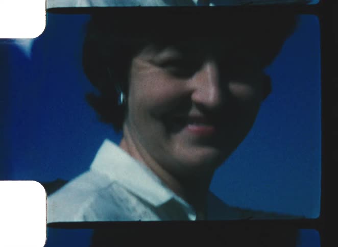 The woman smiles and sticks her tongue out