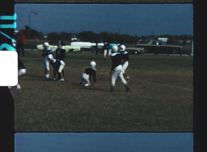Children are playing football and charging forward