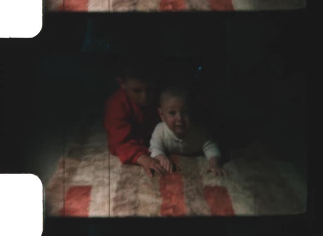 The two boys lay on the rug together