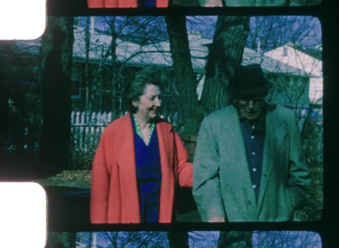 A man and woman standing in a neighborhood
